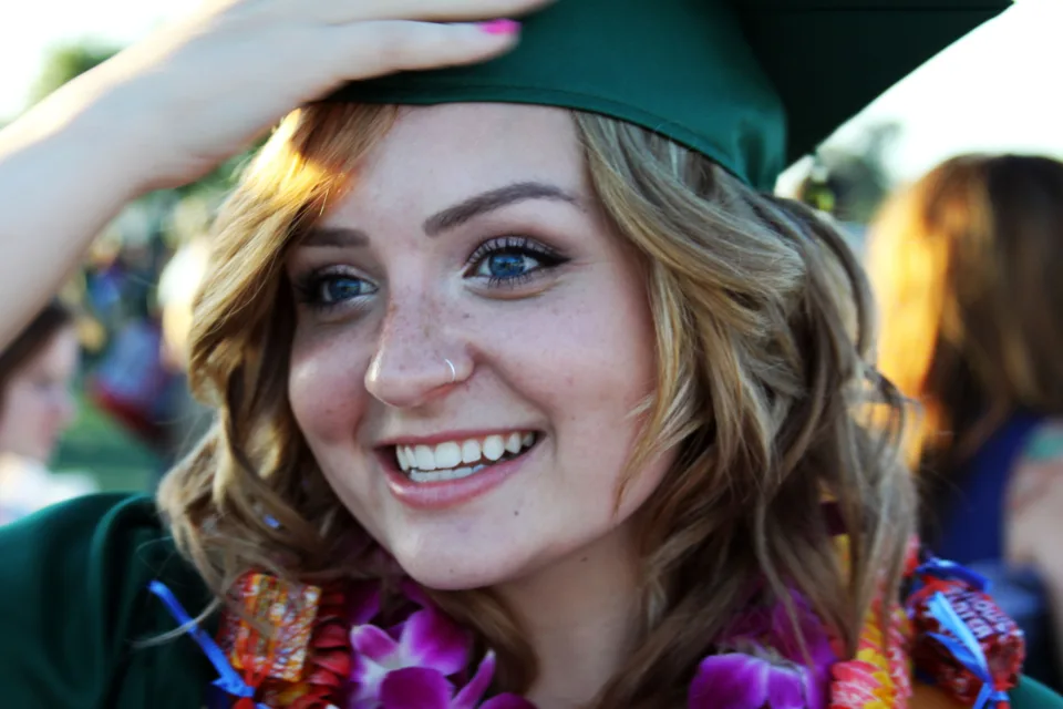Graduates in caps and gowns at a university graduation ceremony